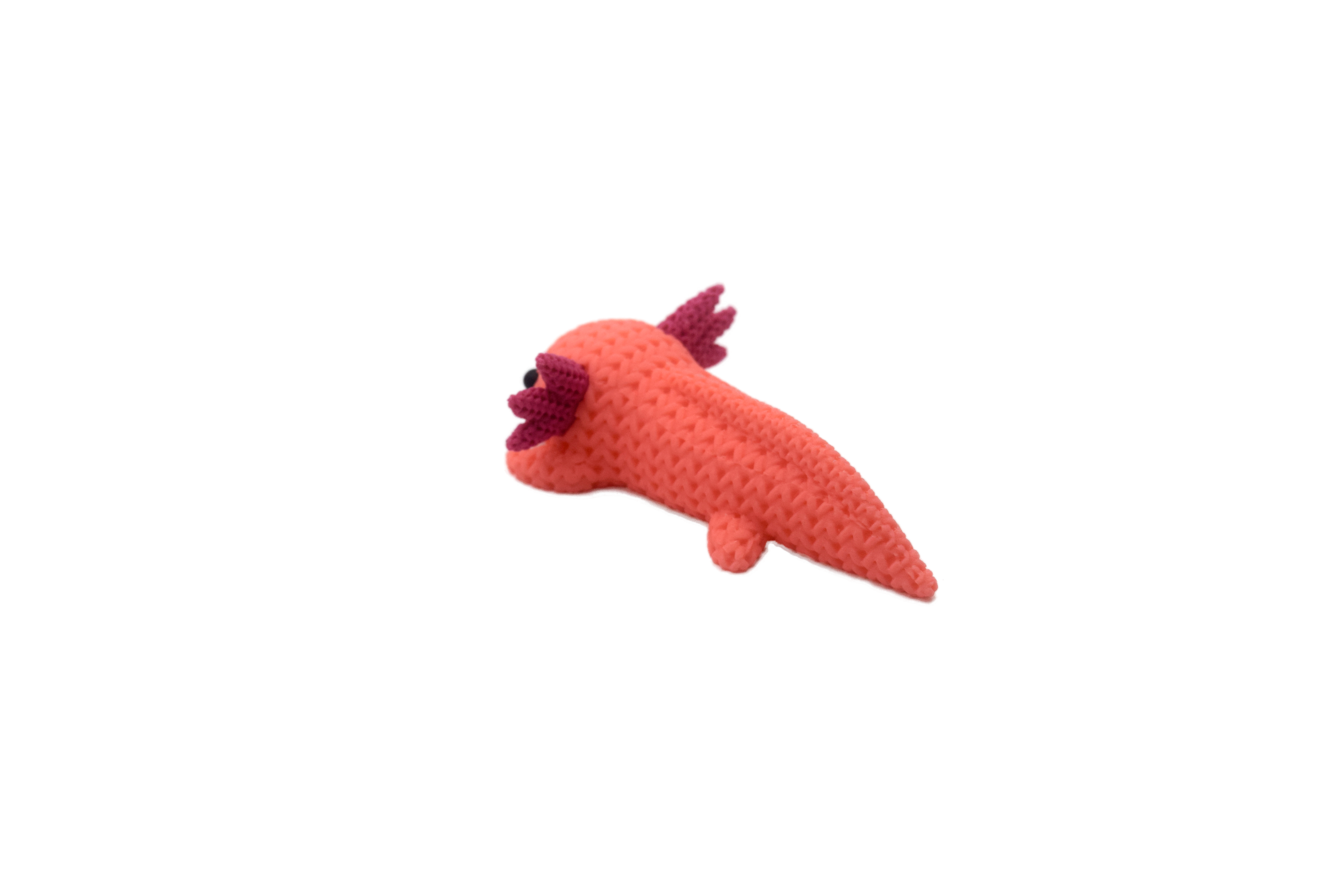 Back of a pink axolotl figure with magenta spikes on a white background