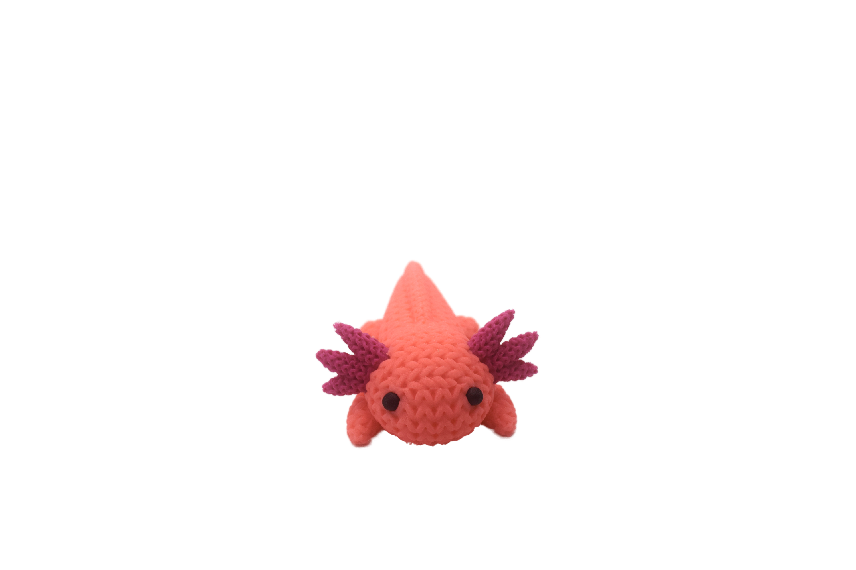 Pink axolotl figure with magenta spikes on a white background