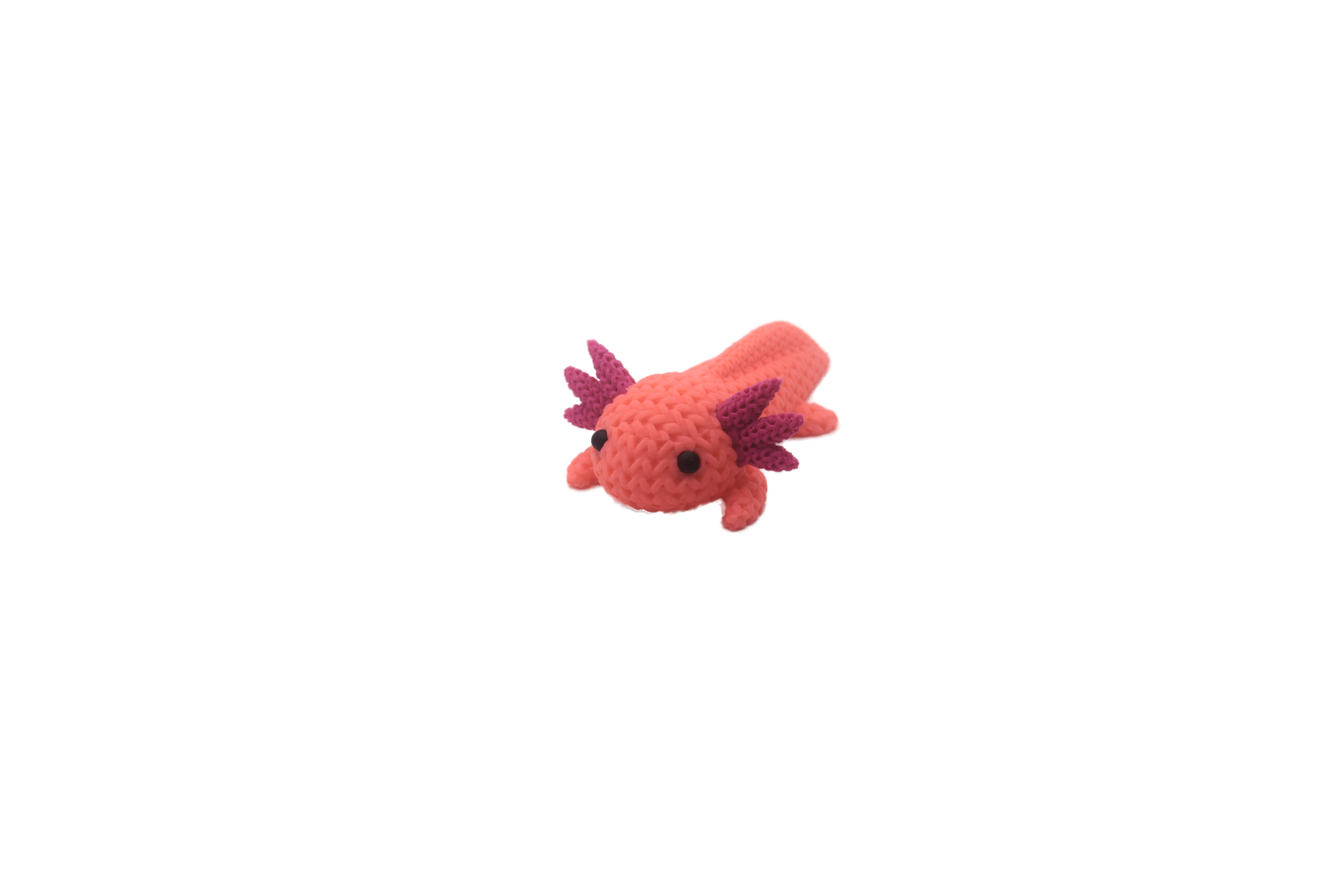 Pink axolotl figure with purple spikes on a white background
