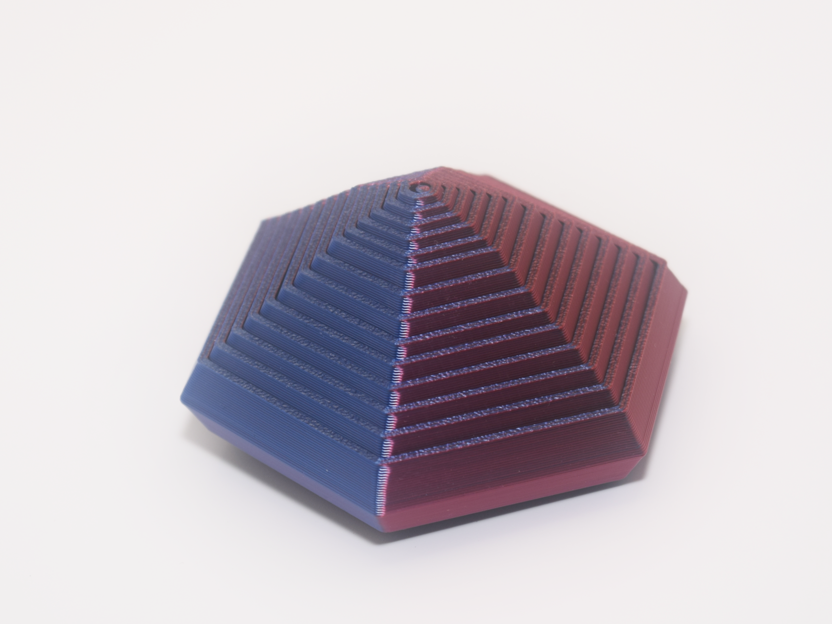 Hexagonal pyramid with blue and red gradient on a white background