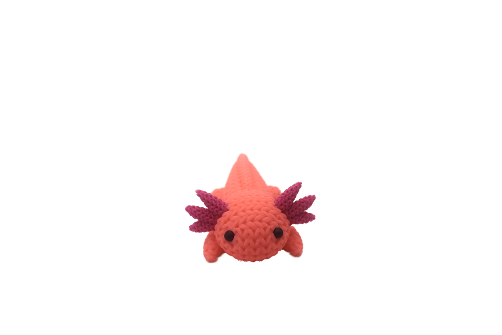 Pink axolotl figure with magenta spikes on a white background