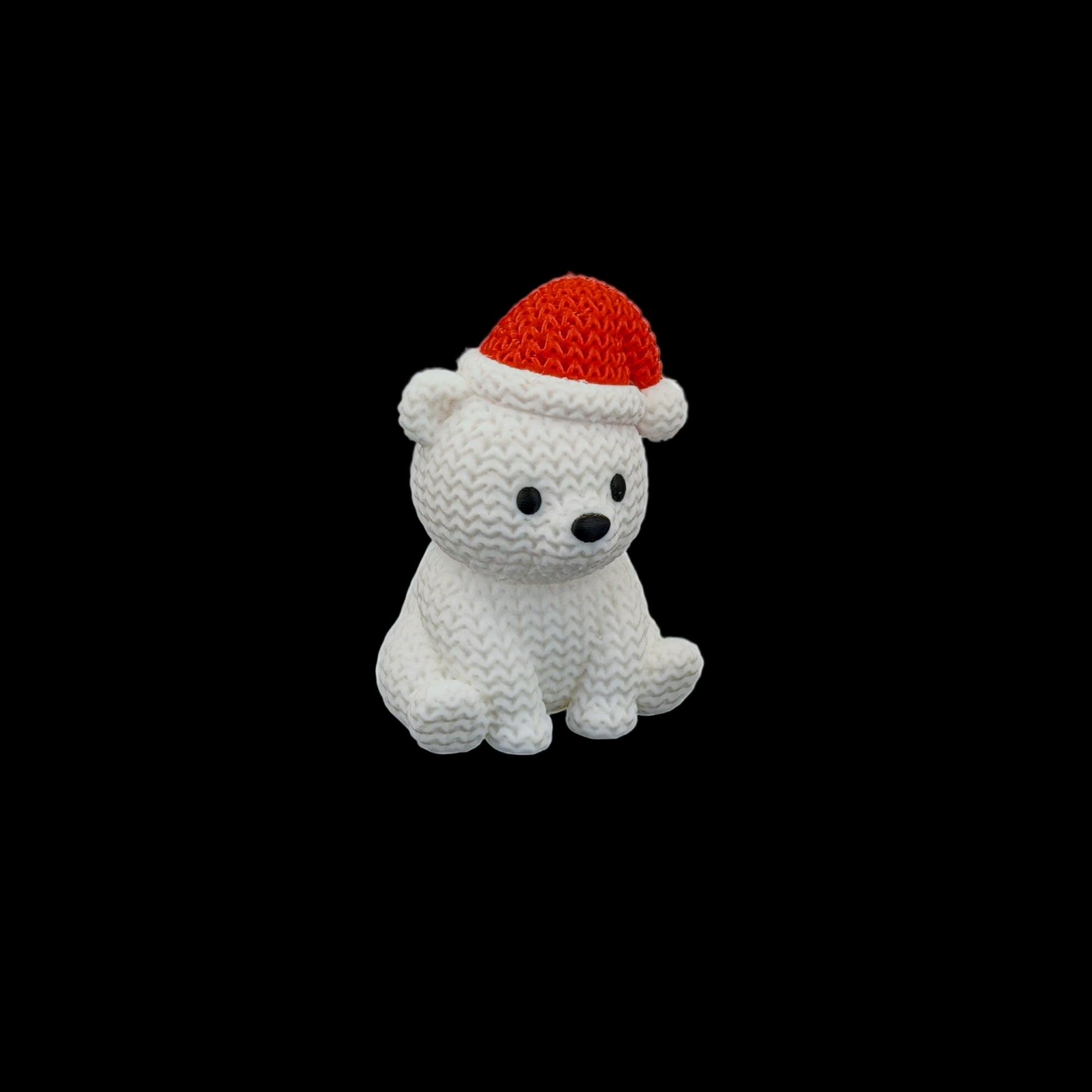 Cute white polar bear (with knitted texture) wearing a red Santa hat, sitting and facing forward.