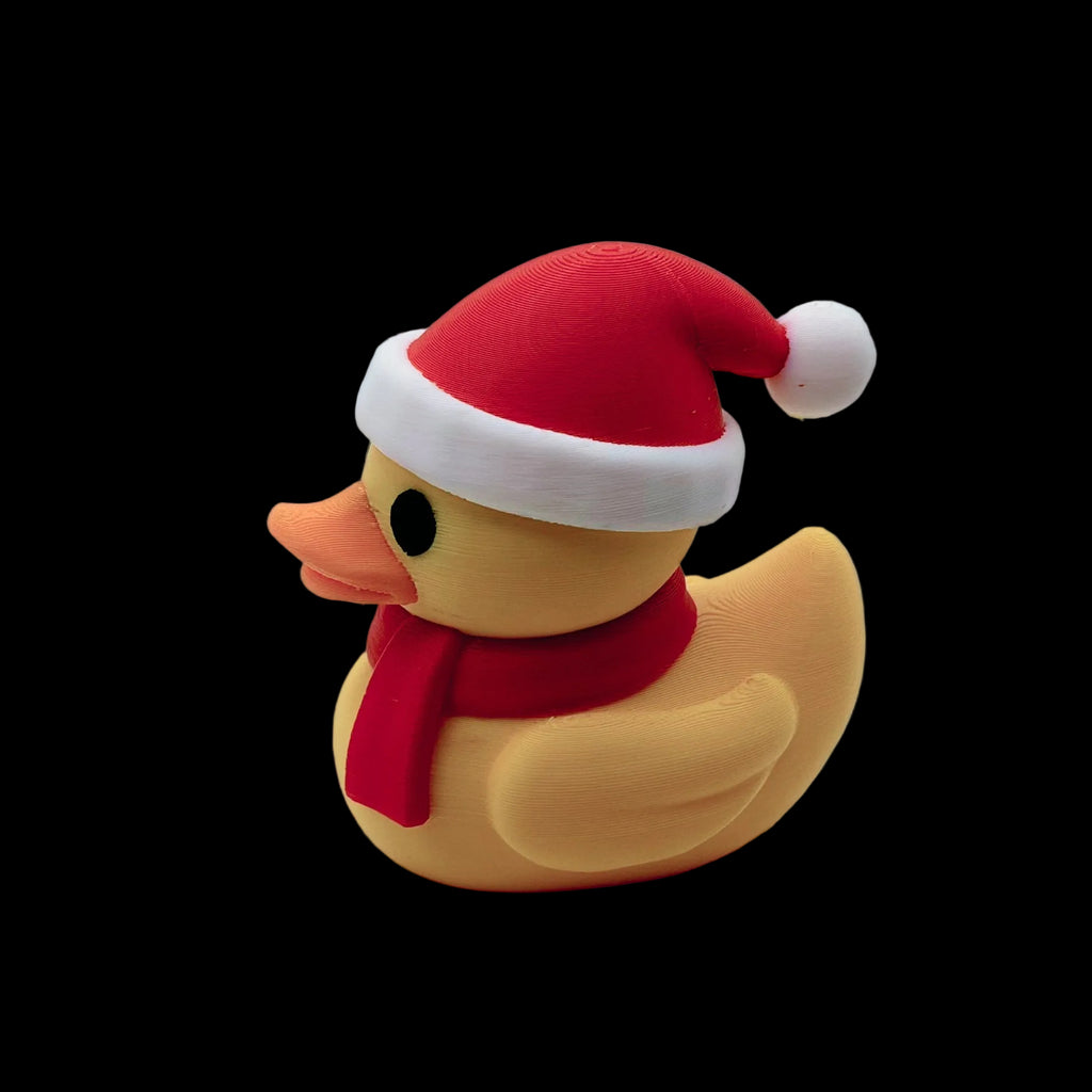 Rubber duck wearing a Santa hat and scarf on a white background