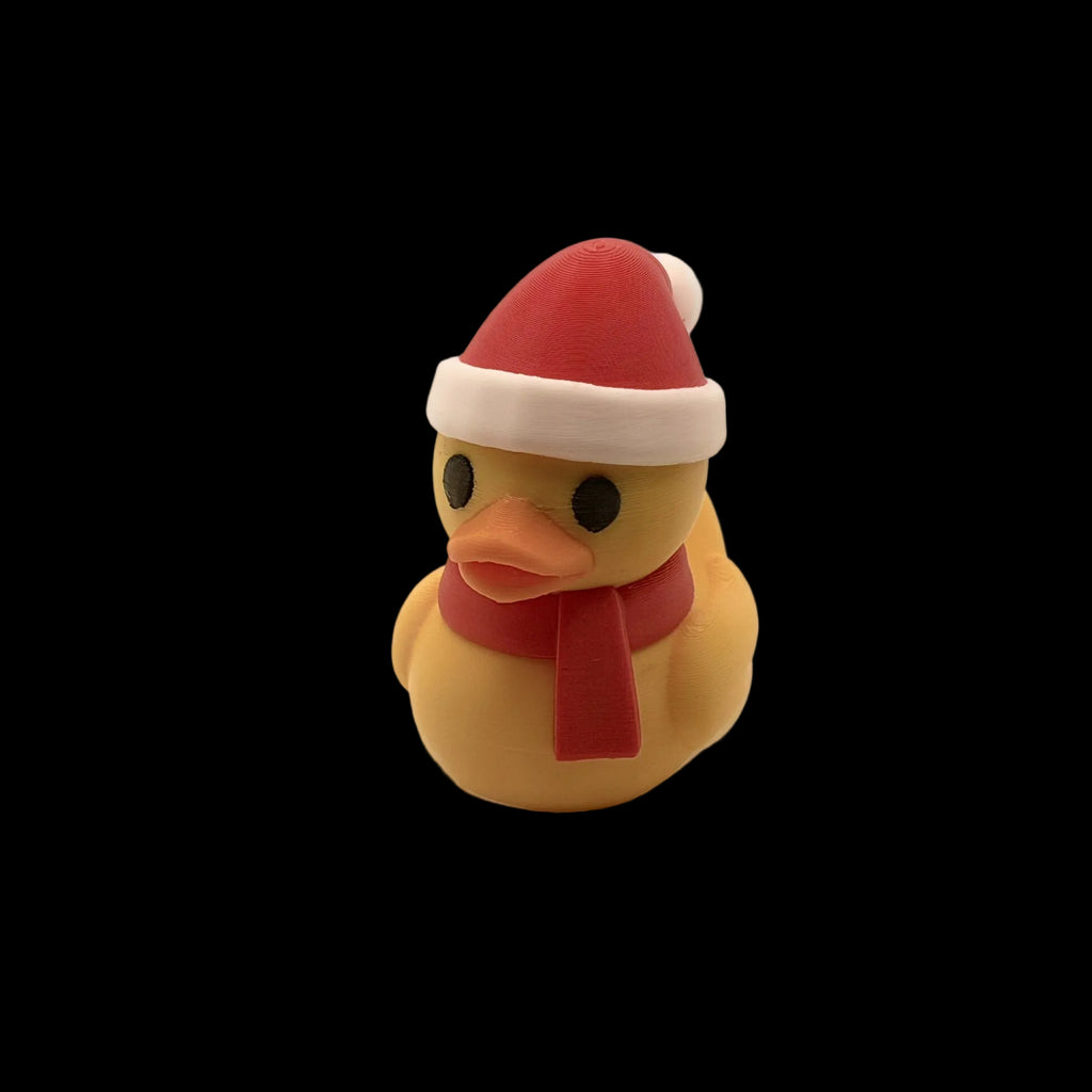 Rubber duck wearing a Santa hat and scarf on a white background